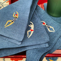 The Voyage Dubai - The Poolside Cocktail Napkins in Denim A chic set of cocktail napkins to elevate your next pool party. A perfect gift for hosts and swimmers alike. Sold in sets of four, with four different motifs in each set.