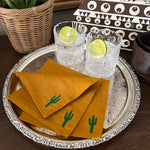 The Voyage Dubai. Dry July Cocktail Napkins  Our desert inspired cocktail napkins are the perfect thirst quenching accessory. Featuring embroidered cacti, they are a fun go-to for summer entertaining.  Our napkins are handcrafted from 100% European linen that has been stonewashed and softened giving them a wonderful, luxurious feel. The cocktail napkins come beautifully presented making for the perfect gift.