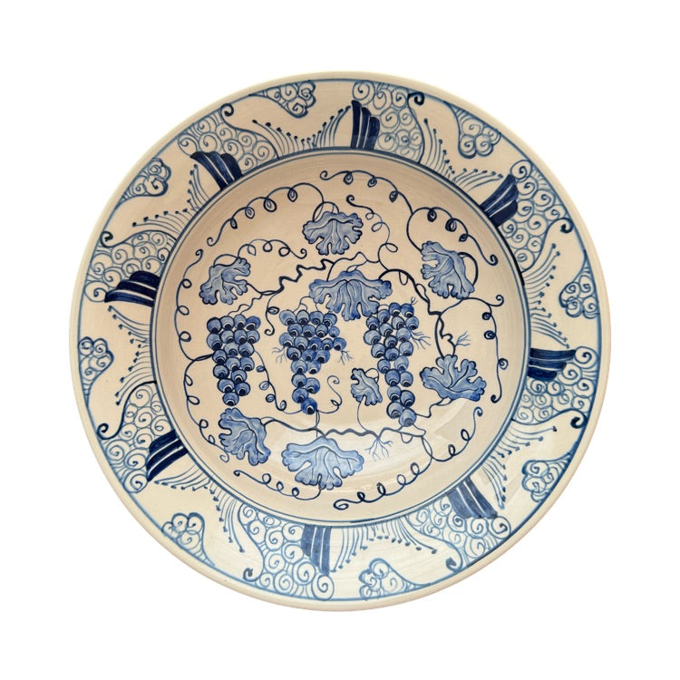 The Voyage Dubai - Hand-painted Iznik ceramic bowl by acclaimed Turkish artist Adil Can Güven. The bowl is painted in a traditional Iznik style featuring a blue and white floral design.