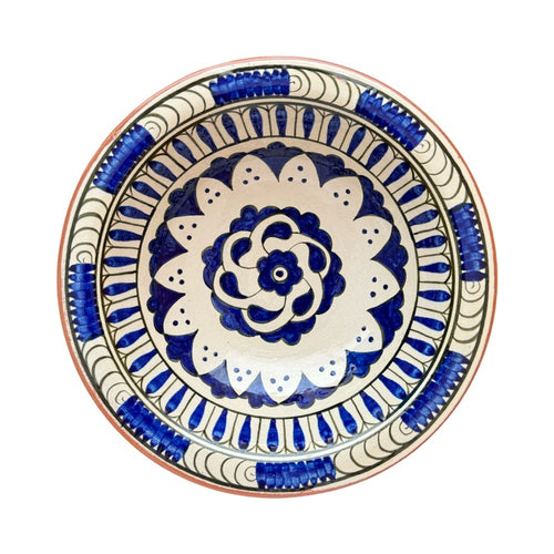 The Voyage Dubai - Hand-painted Iznik ceramic bowl by acclaimed Turkish artist Adil Can Güven. The bowl is painted in a traditional Iznik style featuring a blue and white floral design.