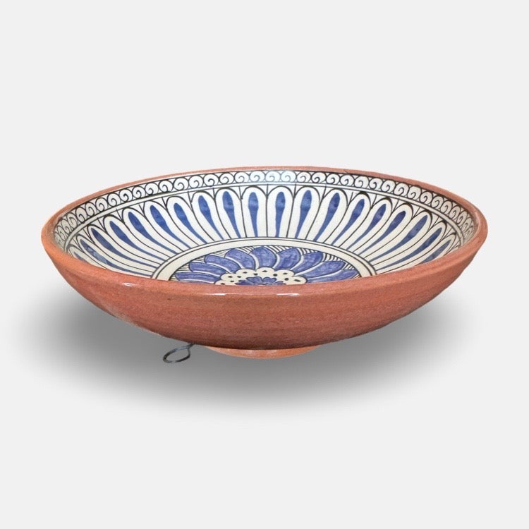 The Voyage Dubai - Hand-painted Iznik ceramic bowl by acclaimed Turkish artist Adil Can Güven. The bowl is painted in a traditional Iznik style featuring a blue and white floral design.