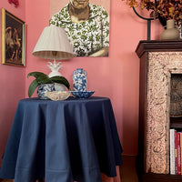 The Voyage Dubai - Round Cotton Tablecloth - Navy  A classic tablecloth in navy cotton finished with a wide hemmed border in the same colour. Perfect as a tablecloth for a smaller dining table or for a skirted side table.