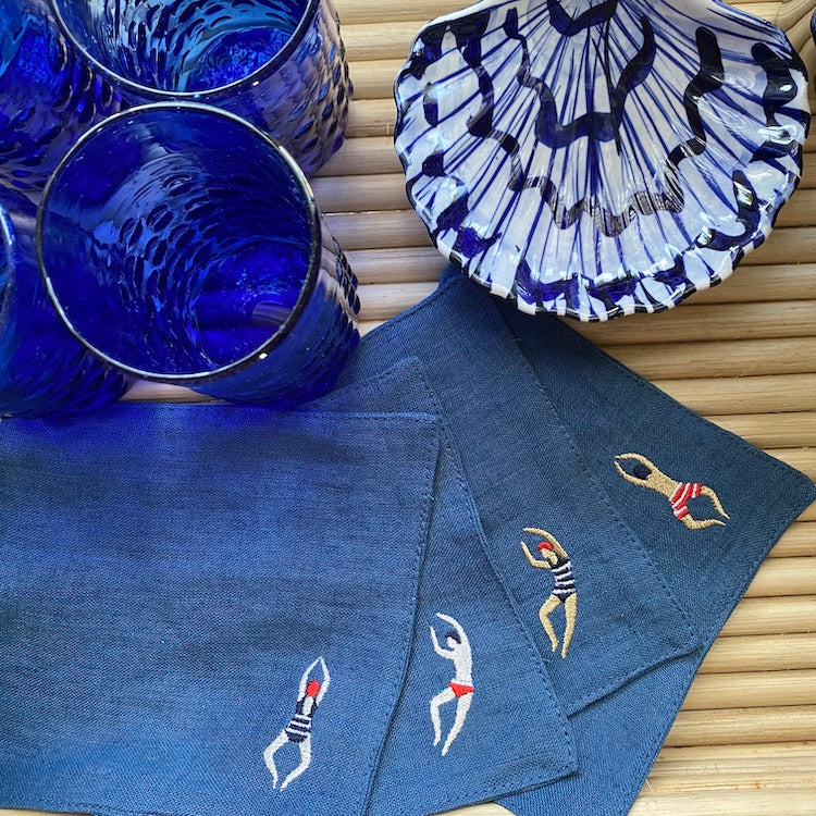 The Voyage Dubai - The Poolside Cocktail Napkins in Denim A chic set of cocktail napkins to elevate your next pool party. A perfect gift for hosts and swimmers alike. Sold in sets of four, with four different motifs in each set.