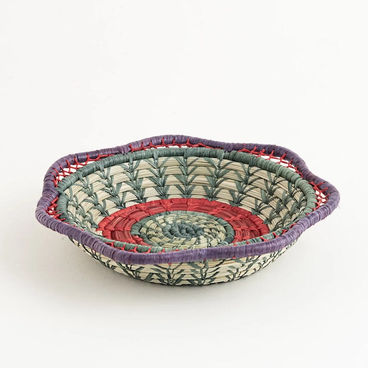 The Voyage Dubai - Fina Basket - Handmade and designed by the women of Mayan Hands El Triunfo cooperative, the Fina basket is a wonderful tabletop accent, delicately handwoven of native grass and pine needles with colorful raffia accents and a scalloped rim.   Handmade and fair trade.  Origin – Guatemala