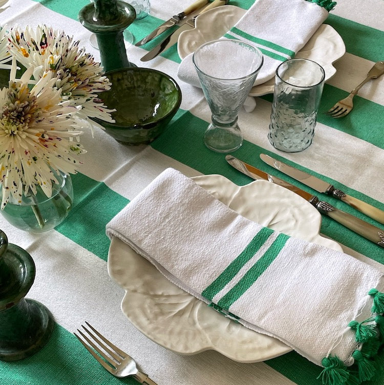 The Voyage Dubai - Made in Tangier Set of 6 Jibli Napkins - Emerald Green Inspired by the Jibli (country) women of Northern Morocco these generously sized table napkins add an element of fun to any table. Available in pure white cotton, as well as fun colourful stripes on a creamy white base, each napkin is finished with matching pom poms. Use as table napkins, tea towels or hand towels.