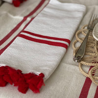 The Voyage Dubai - Made in Tangier Set of 6 Jibli Napkins - Red Stripe Inspired by the Jibli (country) women of Northern Morocco these generously sized table napkins add an element of fun to any table. Available in pure white cotton, as well as fun colourful stripes on a creamy white base, each napkin is finished with matching pom poms. Use as table napkins, tea towels or hand towels.