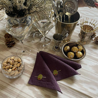 The Voyage Dubai - Shaken not Stirred Cocktail Napkins in Plum  A must-have for all martini lovers, these fun cocktail napkins come in a gorgeous plum colour are sure to elevate your aperitivo hour.  Our cocktail napkins are handcrafted from 100% European linen that has been stonewashed and softened giving them a wonderful, luxurious feel. The cocktail napkins come beautifully presented making for the perfect gift.