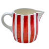 The Voyage Dubai - Milk Jug in Red Stripes  Handmade and hand painted in Malta in contemporary thick stripes, designed to complement the rest of the Villa Bologna collection. The chunky bands of colour are as brilliant on their own as they are when paired with the scroll pattern and/or the Palm pieces.